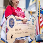 Karen Foley with novelty bone shaped check